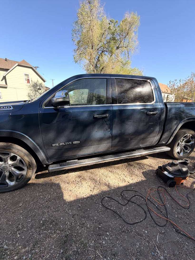 Before — a pickup coated in dust and road film down the whole side