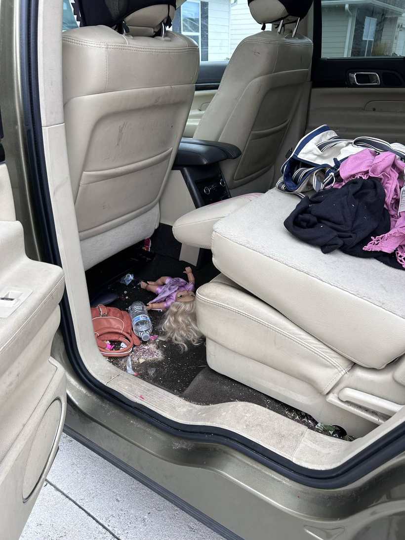 Before — rear seats and floor of an SUV, littered with trash and toys